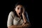 Close up portrait young attractive Latin woman screaming desperate and scared isolated on black