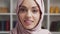 Close-up portrait of young and attractive muslim girl in hijab. Middle Eastern woman is sitting in front of the camera.