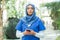 Close-up portrait of young and attractive muslim woman nurse in hijab. Middle Eastern female doctor outdoor on the
