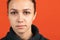 Close-up portrait of young bautiful caucasian girl isolated over red studio background