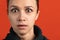 Close-up portrait of young bautiful caucasian girl isolated over red studio background. Shocked facial expression