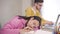 Close-up portrait of young beautiful African American girl sleeping at the table as smart Caucasian boy in eyeglasses