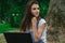 A close-up portrait of young beautiful girls with pensive laptop