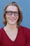 Close up portrait of young blond man wearing glasses, smiling perfect healthy toothy - humor, dentistry or ophthalmology concept