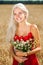 Close up portrait of a young blonde girl with a bouquet of field daisies