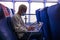 Close up and portrait of young blonde man using laptop and computer pc in a ship traveling in the sea wearig medical and surgical