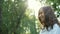 Close up portrait of Young brunette girl looking at camera and smiling. Slow motion. Charming young woman with a