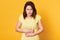 Close up portrait of young Caucasian woman with awful stomachache on yellow background, eats something expired, has intoxication,