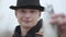 Close-up portrait young confident happy fisherman wearing a cap with a brim in the early morning catch fand showing fish