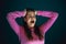 Close up portrait of young crazy scared and shocked woman isolated on dark background