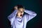 Close up portrait of young crazy scared and shocked woman isolated on dark background