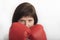 Close-up portrait of young dark-haired woman in red wrestling gloves. Woman boxer