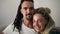 Close up portrait of the young dreadlock couple in love looking directly to the camera and smiling on the white