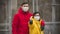 Close-up portrait of young europeans couple in protective disposable medical face mask holding antiseptic. New coronavirus COVID-
