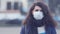 Close-up portrait young europeans woman in protective disposable medical face mask walking outdoors. New coronavirus COVID-19