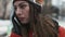 Close-up portrait of a young female sweet talking on telephone outdoors. Girl smiling while have a conversation on