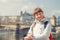 Close-up portrait of young girl tourist looking at camera and smile, Charles Bridge Karluv Most across Vltava river