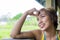 Close up portrait of young happy beautiful Asian woman from Indonesia looking thoughtful and pensive daydreaming and thinking