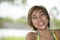 Close up portrait of young happy and beautiful expressive Asian woman laughing excited and nice in positive face expression