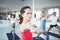 Close up portrait of young healthy woman doing yoga exercise indoor class together with group. Blurred background