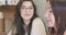 Close-up portrait of young intelligent Caucasian woman in elegant eyeglasses looking at her friend and smiling. Pretty