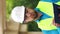 Close-up portrait of a young master builder in a protective hard hat looking at the camera standing at a construction