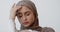 Close up portrait of young muslim lady in hijab suffering from depression, holding her head in despair, slow motion