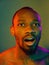 Close up portrait of a young naked african man looking at camera indoors