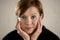 Close up portrait of young red hair sweet and beautiful Caucasian woman looking to the camera relaxed and tranquil smiling happy