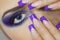 Close up portrait of young woman with big blue eyes and prefect manicure.