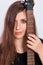 Close-up portrait of a young woman and electric guitar fretboard isolated on white background.