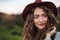 Close-up portrait of young woman traveller standing in nature.