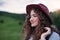 Close-up portrait of young woman traveller standing in nature.