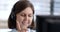 close-up portrait young woman working in the office and talking on a computer headset with colleagues