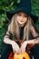 Close-up portrat of little girl in witch Halloween costume outdoor