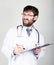 Close-up portret of a Doctor holding a map-case for note, stethoscope around his neck. he discontentedly looking at the