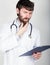 Close-up portret of a Doctor holding a map-case for note, stethoscope around his neck. He rubs his chin. different