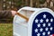 Close-up Of Postman Putting Letters Mailbox American flag