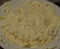 close-up: pot cheese mixed with whisked eggs in a white plate