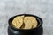 Close up of pot of gold bitcoins on a white and gray crackle background