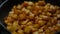 Close-up potato frying on cooking pan in kitchen indoors. Vegetable roasting in sunflower oil closeup.