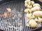 Close up of potatoes, with a bay leaf inserted inside, resting o