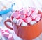 Close up of pots of multiple white marshmallows lying on table