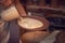 Close Up Of Potter Applying Glaze To Clay Plate In Ceramics Studio