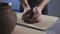 Close up of Potter kneads the clay in slow motion