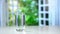 Close-up pouring purified fresh drink water from the pitcher on table in kitchen