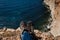 Close up POV of hiking boots of an independent male traveler on top of a mountain, looking at the view