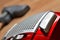 Close-up of power button of vacuum cleaner on floating floor and noozle in background - limited depth of field