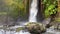 Close-up of powerful raging Sumampan waterfall with turbulent water. Crystal clear stream of glacial water falls from