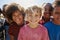 Close up of pre-teen friends in a park smiling to camera